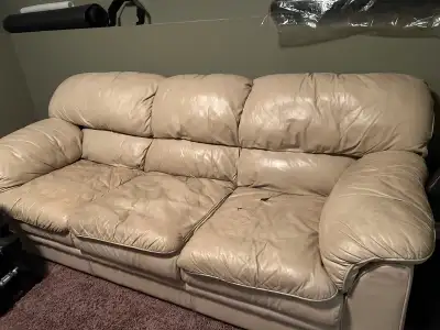 Free! Cream leather large couch and love seat. Couple of holes in cushions. Frame solid.