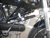 Motorcycle long stroke steering damper side frame shock mount