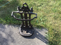 Antique cast iron walking stick or fire place accessory holder.