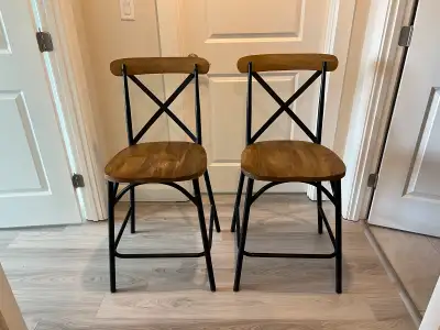 Two bar height stools, excellent condition. Seat height 24 inches. Top of back rest is 39 inches tal...