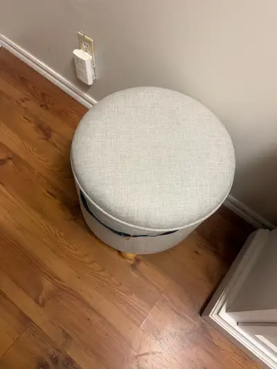 This round ottoman with storage is a stylish and functional addition to any room, providing both sea...