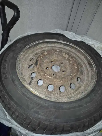 This is a used General Altimax Arctic tire, sized 195/65R15, mounted on a steel rim. Used on a 2013...