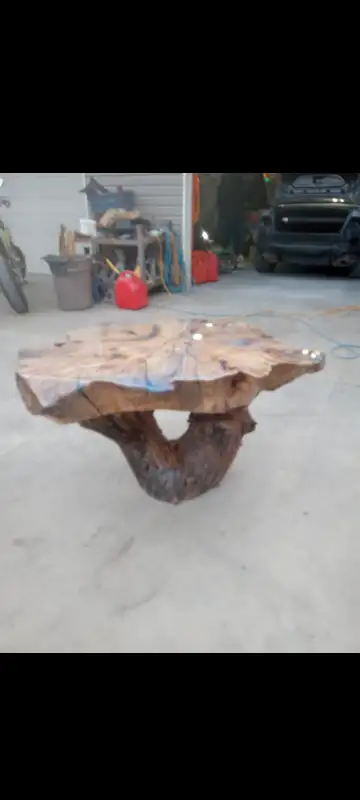 Hello This peice is a beautiful one of a kind table made out of an old willow tree. Great statement...