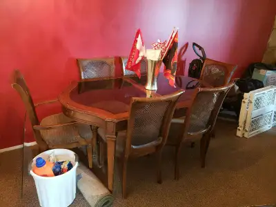 This dining room table and chairs have been in the family for a long time and all material on the ch...