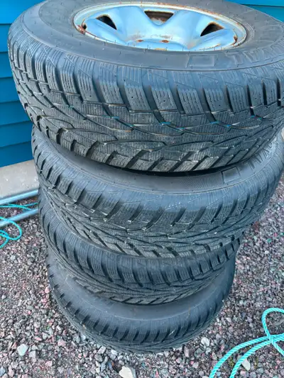 Toyota Tacoma steel wheels and winter tires with nice 245/75R16 Uniroyal ice snow tires in great con...