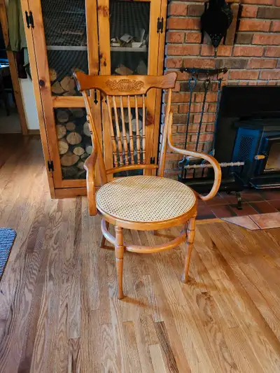 This beautiful solid wood chair is very unique. It has caning on the seat and bentwood arms. The sea...