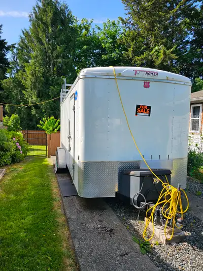 White 18' cargo trailer in great condition, has two built-in power supplies, auto interior lights, r...