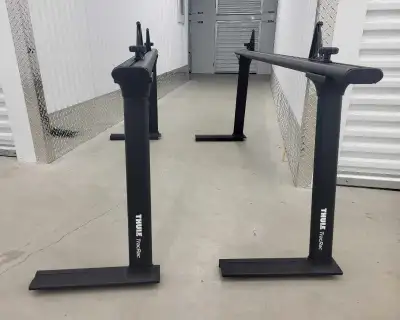 Virtually new Thule Tracrac racks for truck bed. Have never been used. Complete with mounting clamps...