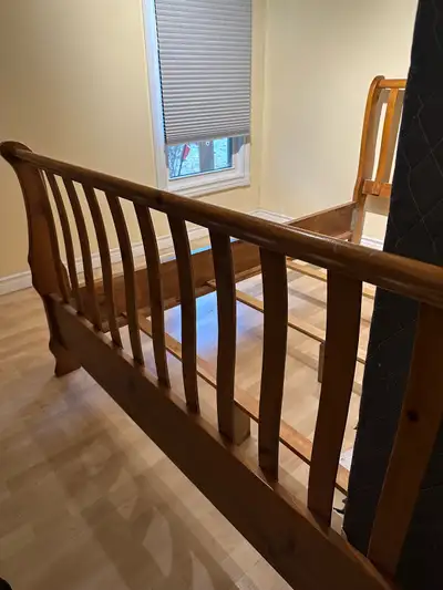 This queen-size sleigh bed frame is made of solid pine wood and features a classic design. It's stur...