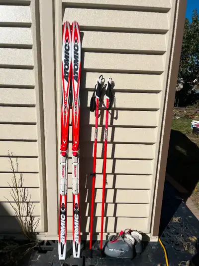 150 Atomic ski with boots size 5 US . Atomic poles ., View more