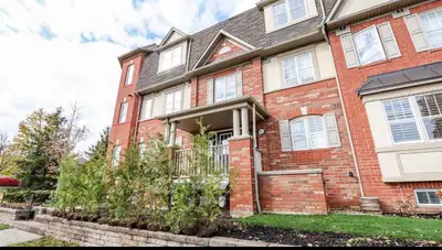 Skip the high-rise elevators. This stacked townhouse offers maximum privacy, direct garage access, a...