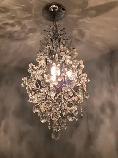 Chrome and crystal chandelier with three dimmable LED bulbs. Measures 12” in diameter by 24” high.
