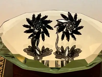 These clip on Sherman earrings have a pinwheel style with a clustered centred . Overall in great con...