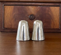 A contemporary salt and pepper shaker set in brilliant pewter