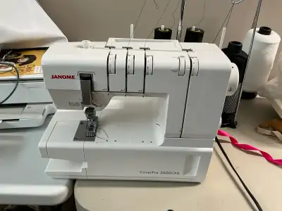 I am selling a Janome CoverPro 2000CPX coverstitch machine, known for its professional-quality hems...