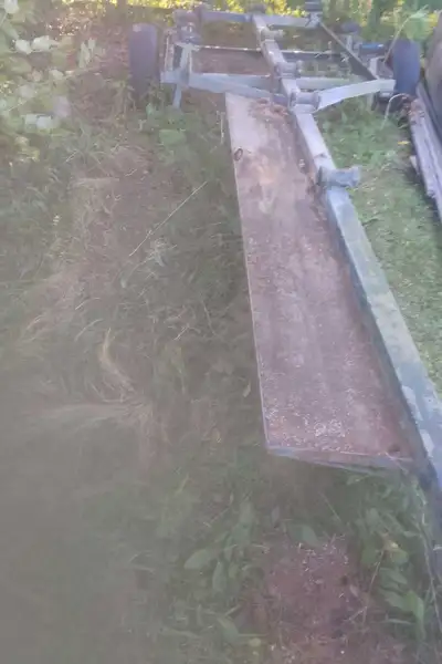 Older boat trailer looks homemade but solid. It had a 16ft fiberglass boat on it. Will need new whee...
