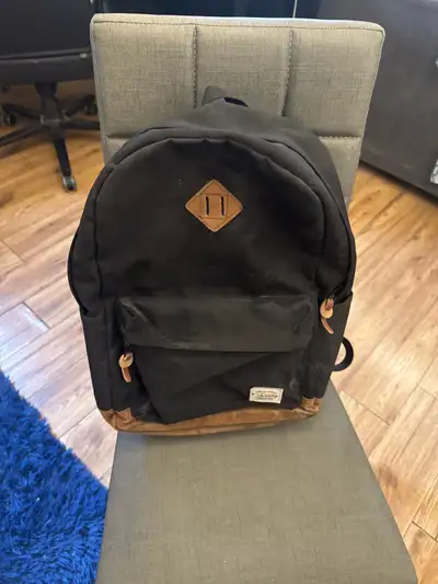 This is a black Tracker backpack, perfect for school or day trips! It features a main compartment, a...