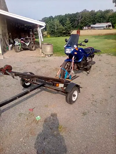 Easy load trailer . Tilts to load and winch pulls bike up with ease. Comes with new spare tire.