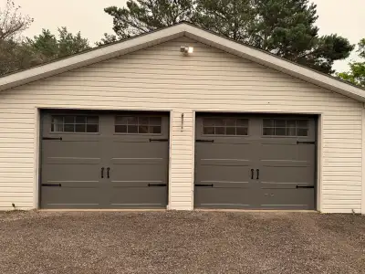 Two 9’ × 7’ Insulated Carriage Style Garage Doors, View more