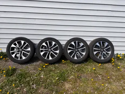 OEM Honda Civic 16” alloy rims with 205/55R16 all-season tires. Tires still have usable tread — abou...
