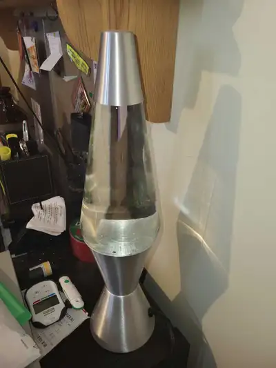 This pre-owned Lava lamp features a sleek, modern brushed silver base and cap design, perfect for ad...