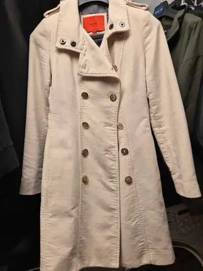 This is a stylish Mango trench coat, perfect for transitioning between seasons! It's a beige colour...