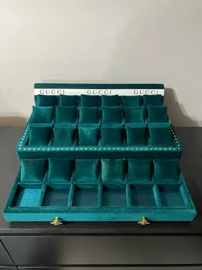 Selling a green velvet Gucci jewelry/watch display. It's in great condition and perfect for storing...