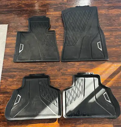 These are genuine BMW all-weather floor mats, designed to protect your vehicle's interior from the e...
