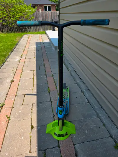 MADD GEAR VX90 PRO STUNT SCOOTER AND STAND. USED ONLY 3 TIMES, PAID $150 EACH, HAVE 2 FOR SALE, EXCE...