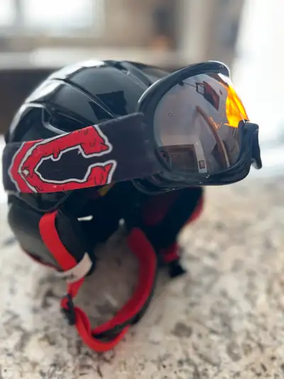 Black Capix helmet and goggles with red accents. Combo - to be sold together. Youth size small (50-5...