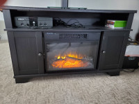 Tv console with electric fireplace.