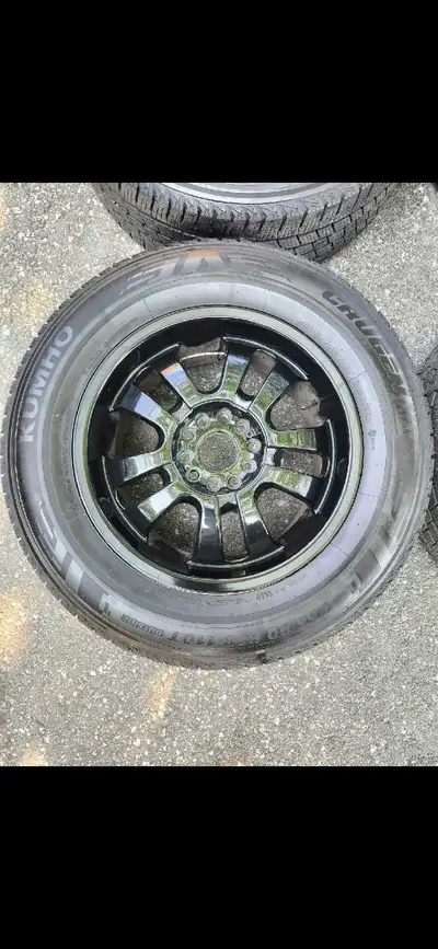 Used 265/60 110T Kumho tires with black rims.
