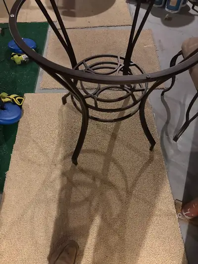 Metal frame table with a glass top. The set includes four matching chairs. The frame and chairs are...