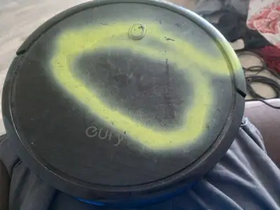 This Eufy Robot Vacuum is used and has been 'decorated' with some yellow spray paint on the top and...