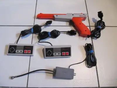 Up for sale is a classic Nintendo Nes 1985 four piece lot consisting of a Duck Hunt Zapper Gun; Two...