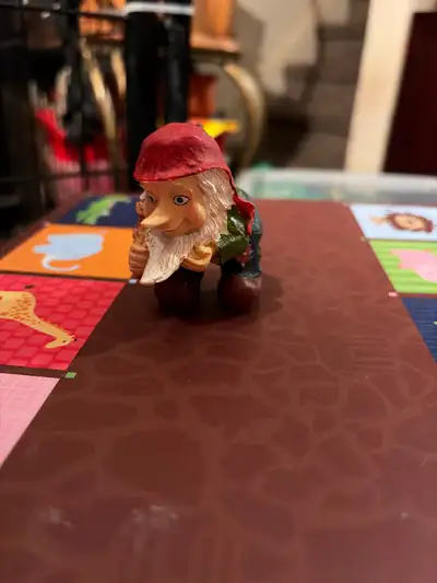 This is a delightful, used gnome figurine ready to bring a touch of whimsy to your home or garden. W...