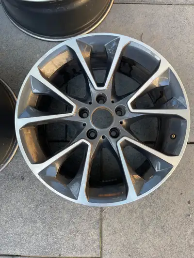 Four genuine BMW X5 OEM rims, featuring a sleek multi-spoke design that enhances the aesthetic of yo...