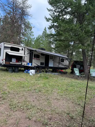 Step inside this Outback Super Lite 325BH by Keystone RV which features a bunkhouse, front bedroom,...