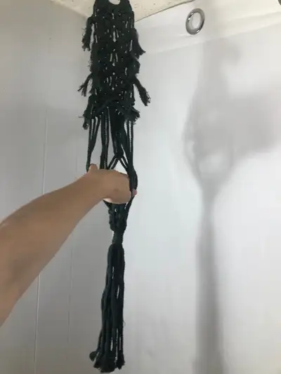 Green Woven Macrame Plant Hanger. NEW. Will hold up to a 6” pot Can also hang in a wall. Brand new....