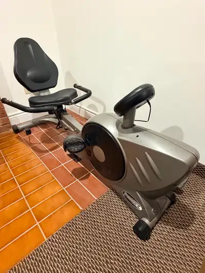 Free Spirit recumbent exercise bike with a digital exercise computer. The reclined seat and back sup...