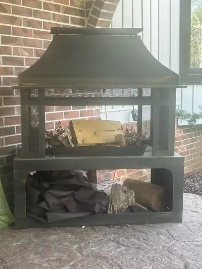 This is an outdoor fireplace that offers warmth and ambiance to any outdoor setting. This used firep...