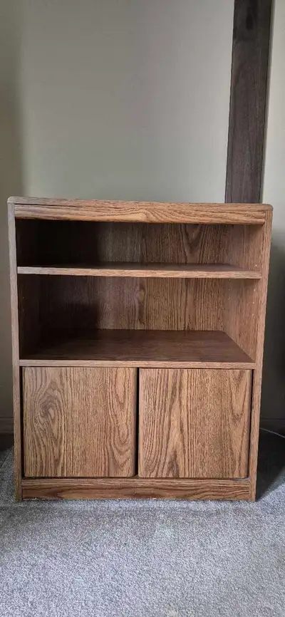 This pre-owned oak storage cabinet features a classic wood grain finish and provides versatile stora...