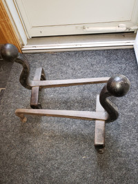 Antique steel andirons for sale.