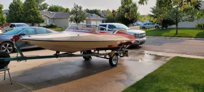 1972 Glastron GT150 with 65HP Evinrude 2 stroke outboard motor. Sitting on a 1972 homebuilt trailer....