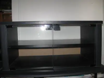 TV table - black finish - clear glass doors - new - $ 50, View more