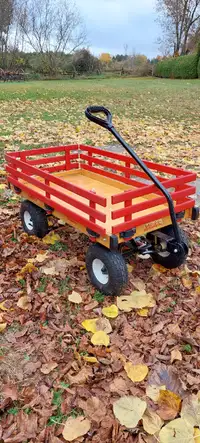 Childs wooden wagon with rubber air tires, racks are removable.