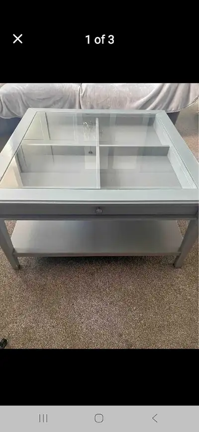 This is a discontinued Ikea LIATORP coffee table with a glass top, drawer, and display. It's in used...
