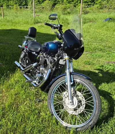 This 2004 Harley-Davidson Sportster XL1200C is a classic cruiser featuring a reliable V-twin engine...