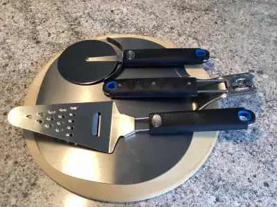 Napoleon pizza stone kit, including 14” stone, adjustable pizza peel, spatula with cheese grater, an...