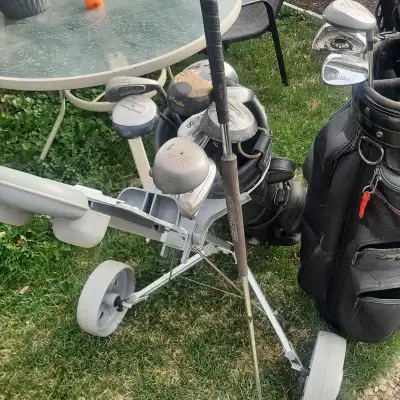2 full sets of golf clubs with bags and pull carts.  $20 per set, View more